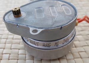 Synchro motor removed from valve showing cog wheel