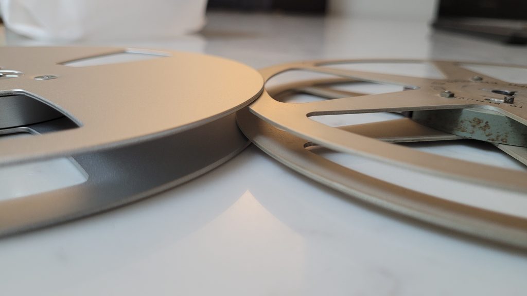 Shows a ferrograph spool slotting inside the new aluminium spool indicating the thicker size difference.