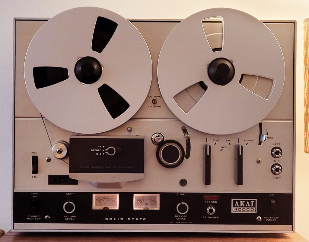 Shows an Akai 4000D with silver aluminium metal spools