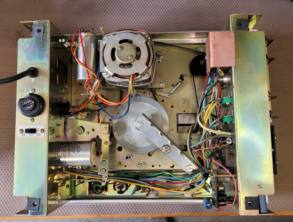 Real view inside showing motor top centre with edge connectors to the right and power transformer on the LHS