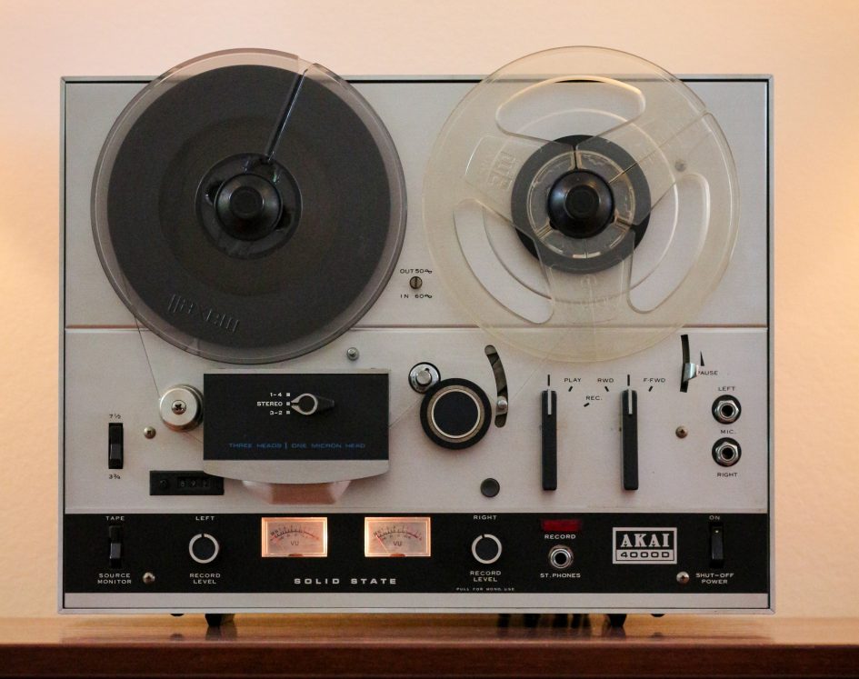 Akai 4000D front showing tape transport loaded with illuminated VU meters, head switch and separate L & R record level controls