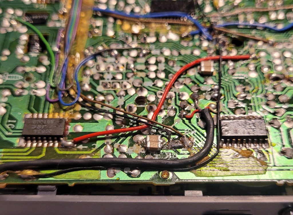 Shows a pair of multilayer ceramic capacitors soldered directly on the PCB to replace the micro Nichicon electrolytics.