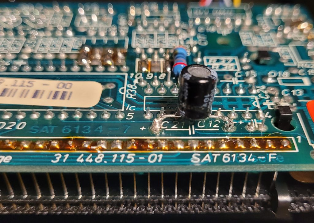 Shows a radial electrolytic mounted solder side across the suspect axial capacitor under the LCD.