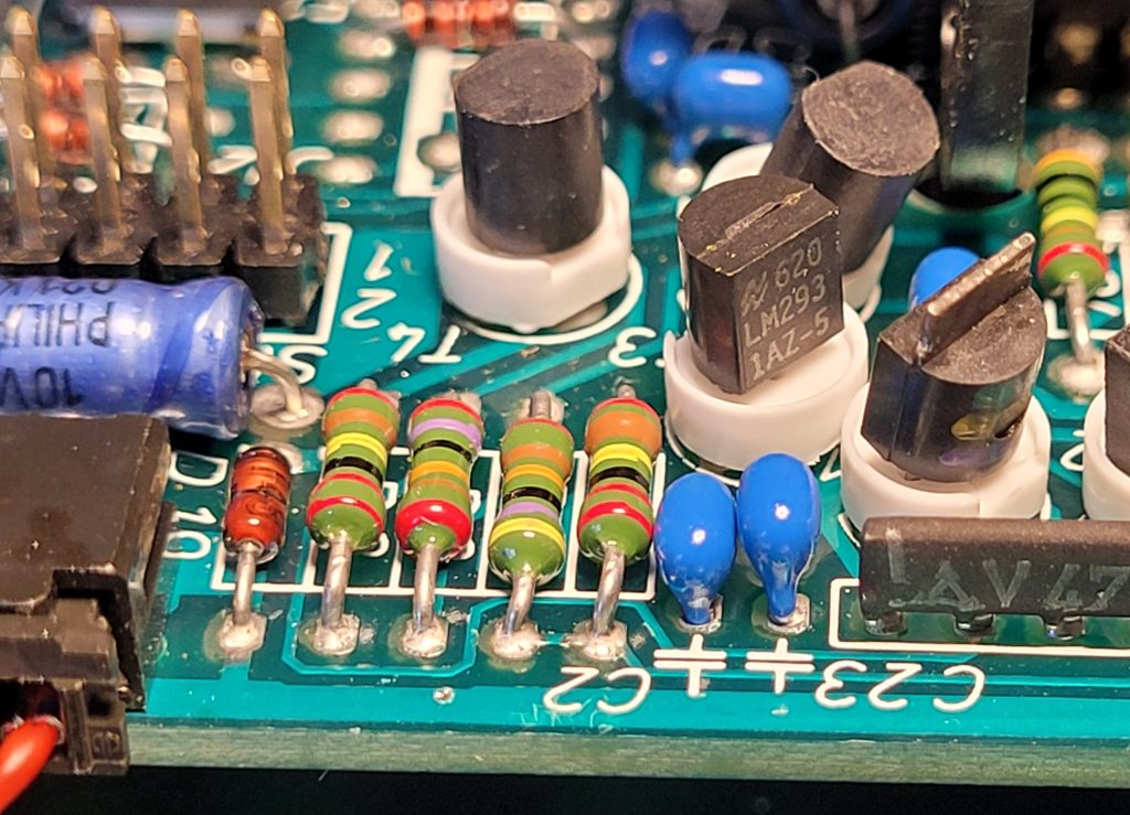 Shows two miniature ceramic capacitors adjacent to the LM293 5V regulator.